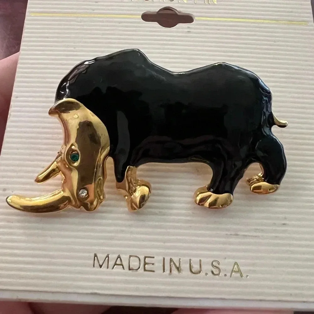 Vintage Black and Gold Rhinoceros Brooch with green sparkling eye